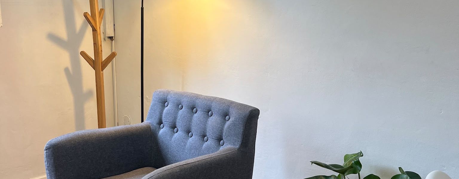 La stanza dello studio vista per intero, con le poltrone, il tappeto e la grande finestra